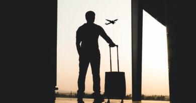 silhouette of man holding luggage inside airport