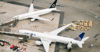 white and red airplane on airport during daytime