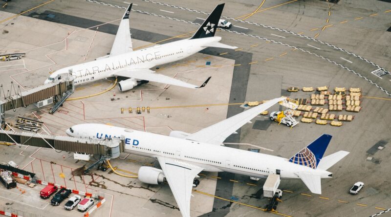 white and red airplane on airport during daytime