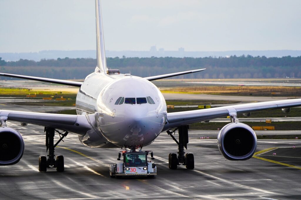 white and blue airplane on airport during daytime