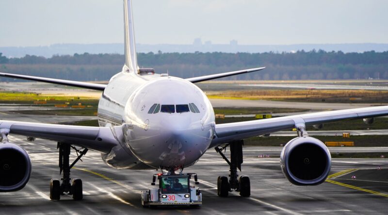 white and blue airplane on airport during daytime