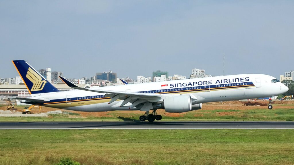 white and blue passenger plane on runway