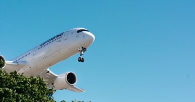a large passenger jet flying through a blue sky