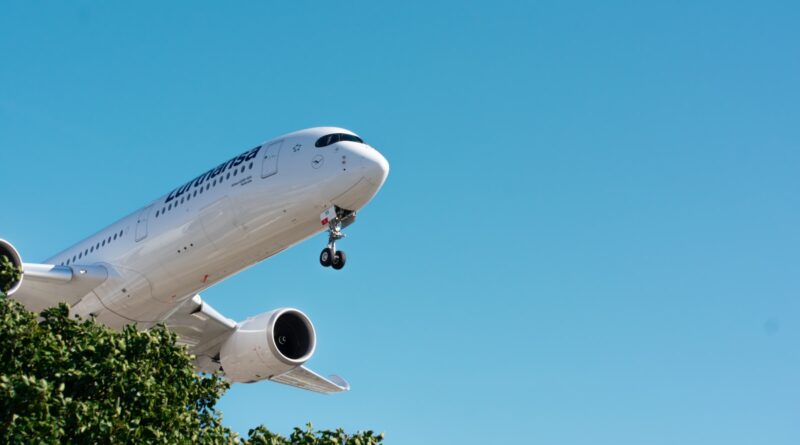 a large passenger jet flying through a blue sky