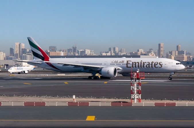 white and red airplane on airport during daytime