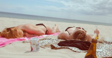 brown glass bottle across two women